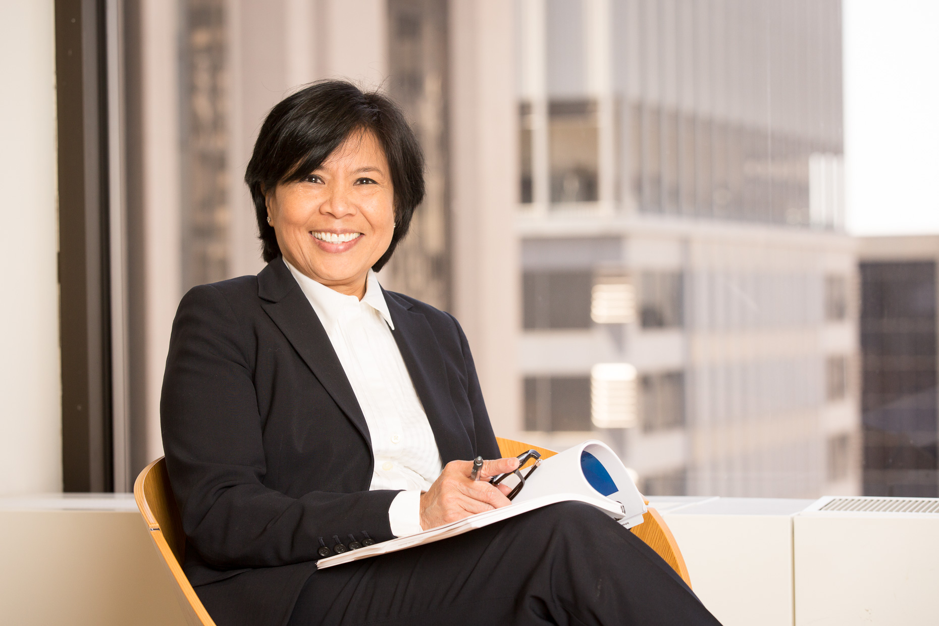 Environmental portrait of business woman in corporate office setting by David Zaitz
