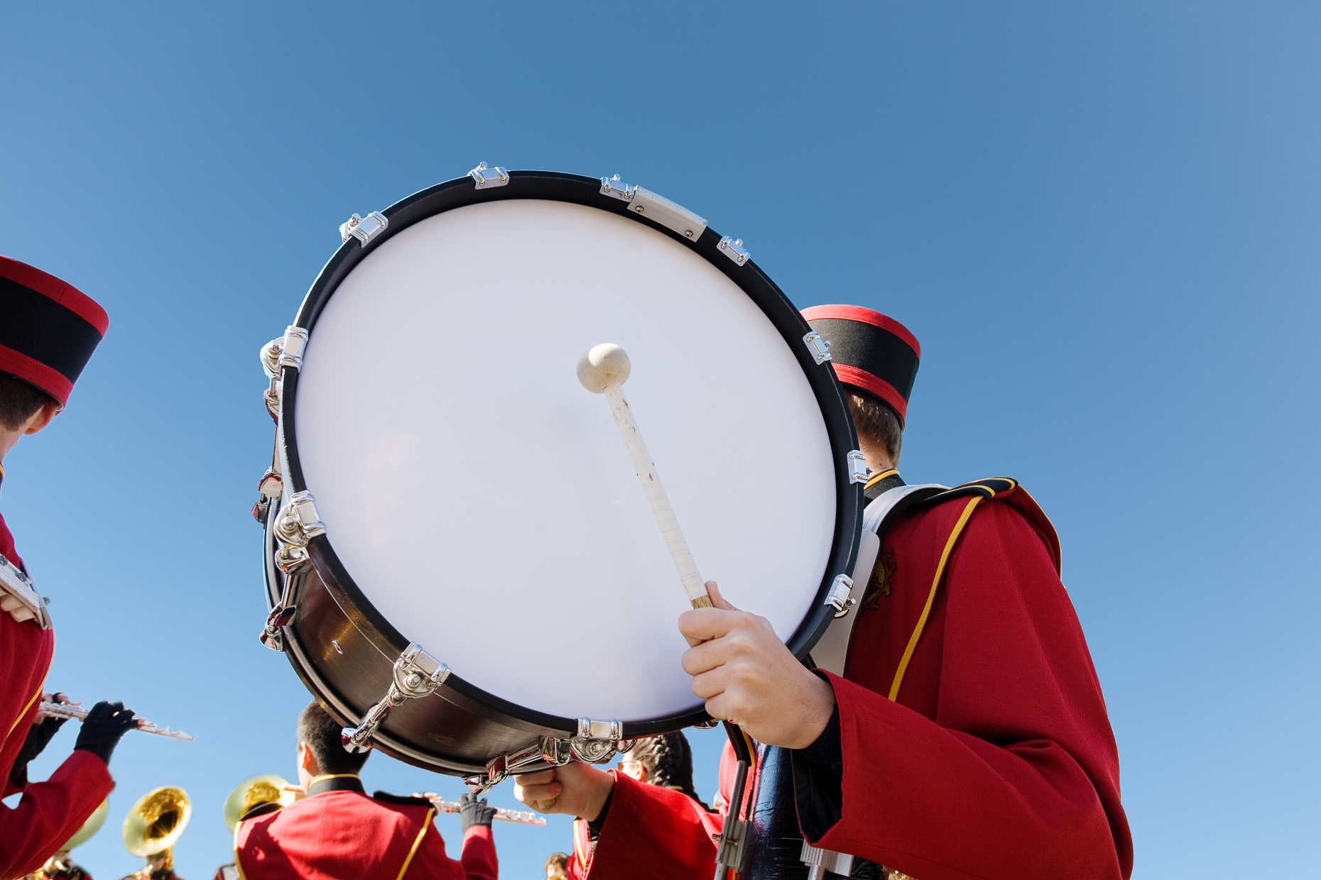 Bass Drum Of Marching Band Being Held By Band Member In Uniform Against Blue Sky By David Zaitz 8662