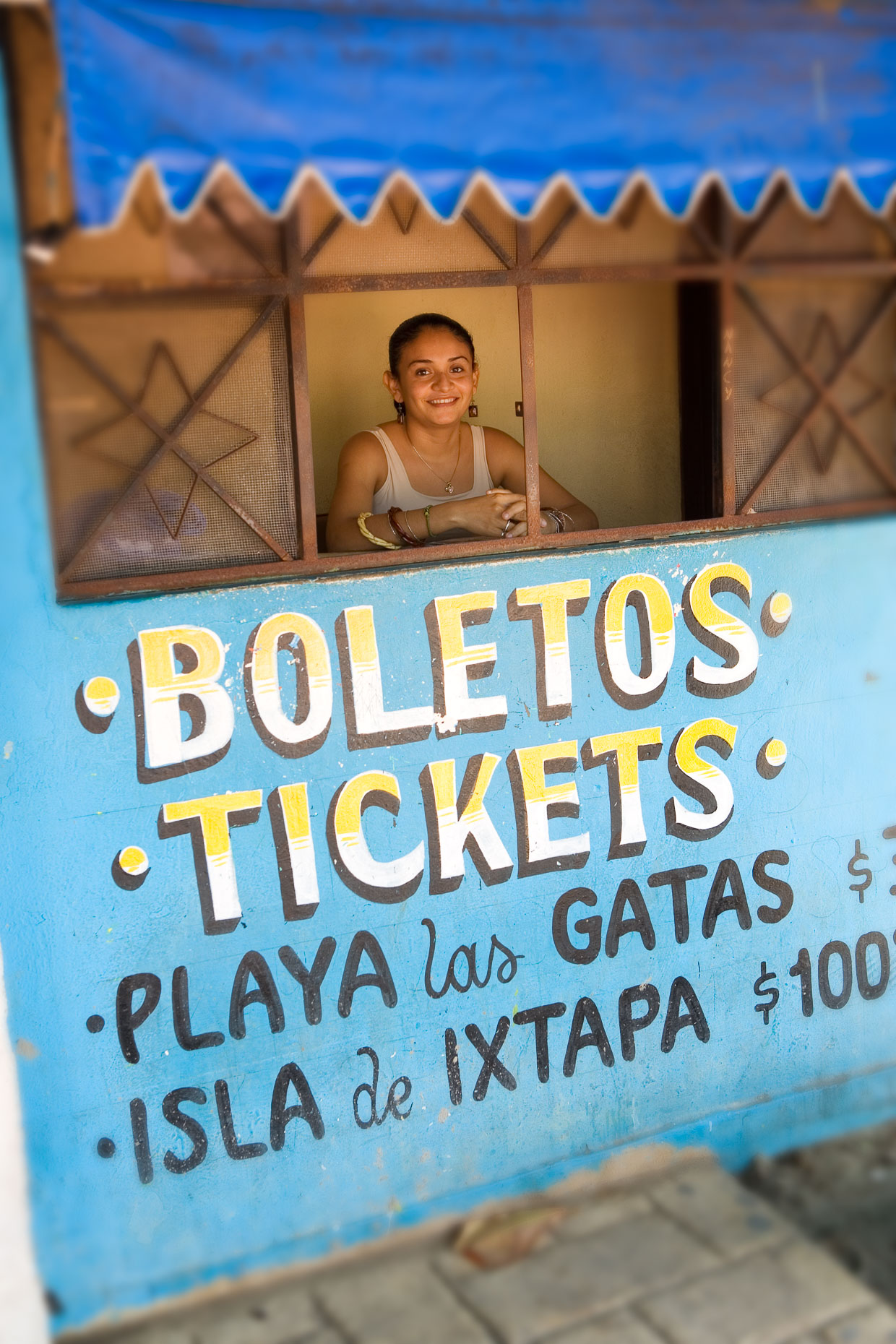 Woman female in ticket booth in Zihuatanejo Mexico.