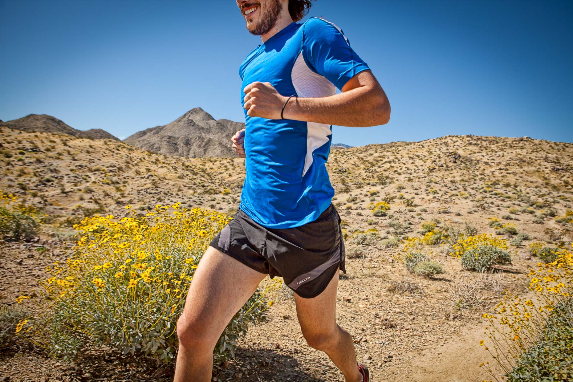 Torso of man running on desert trail in Palm Springs, California. Fitness. David Zaitz Photography.