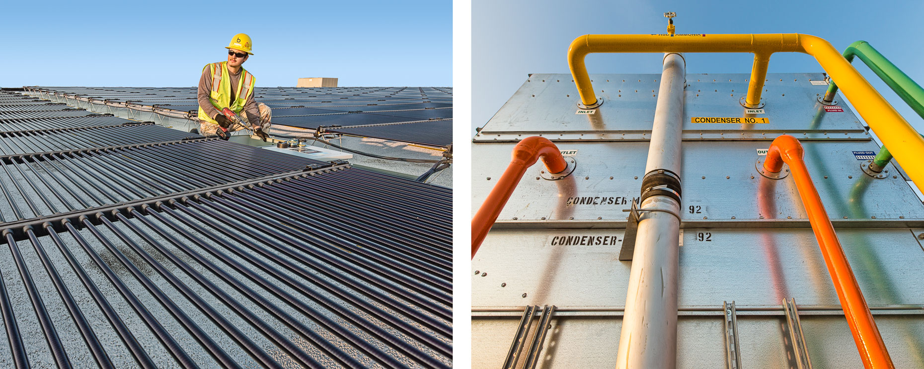 Man with hard hat working on solar power array on roof of factory and colorful pipes on condenser against sky. Industrial. David Zaitz Photography.