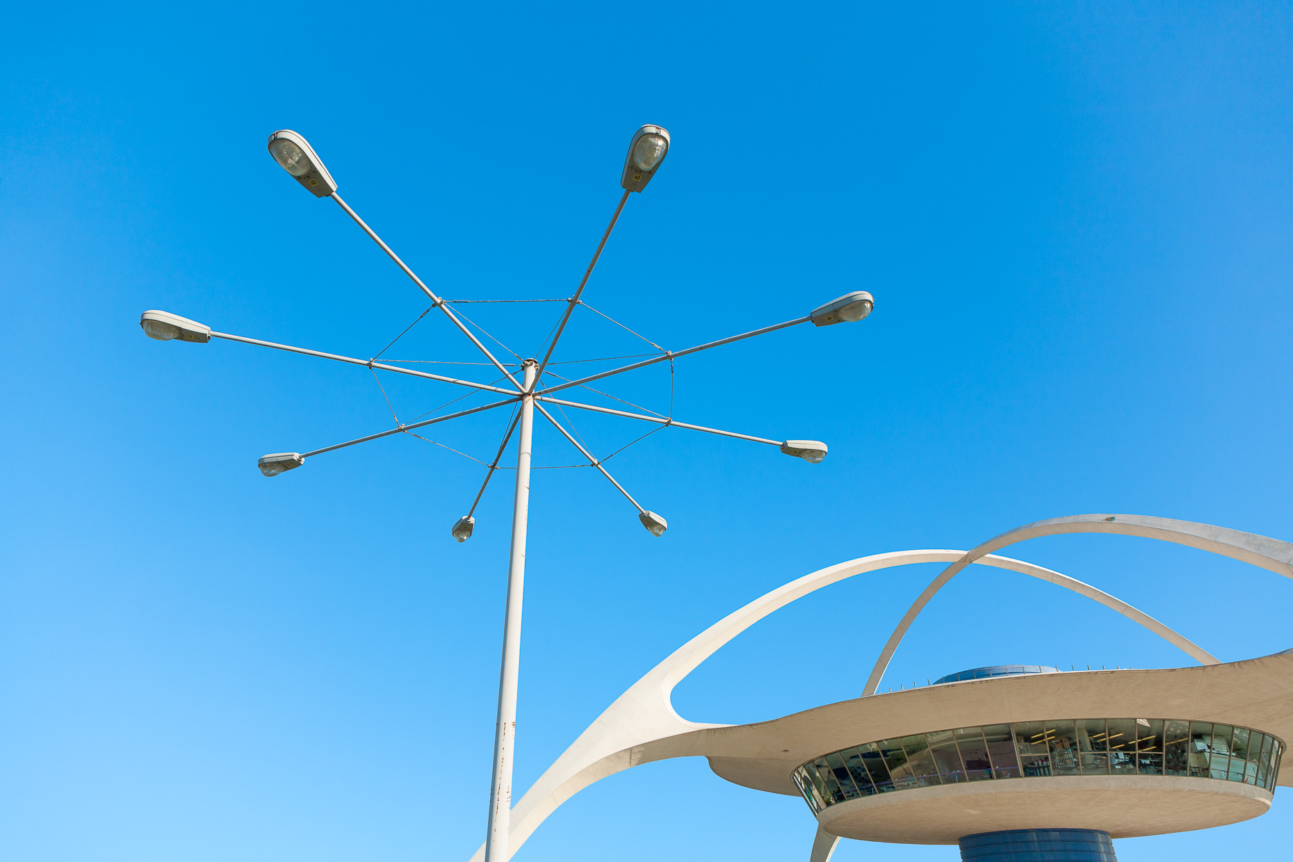 Midcentury modern Theme Building with street light against sky at Los Angeles International Airport. Architecture.  David Zaitz Photography.