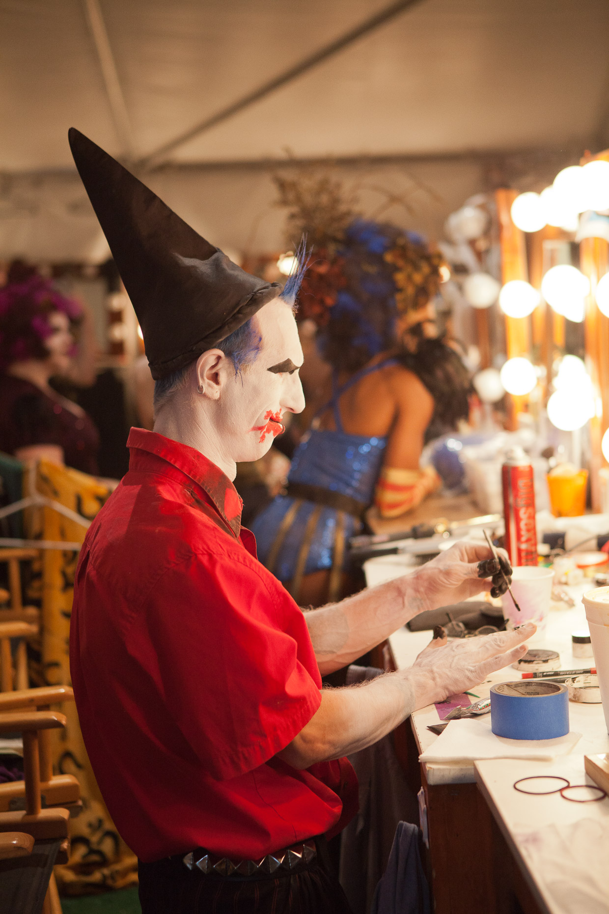 Performer applying makeup backstage at Cirque Berzerk circus performers, by David Zaitz