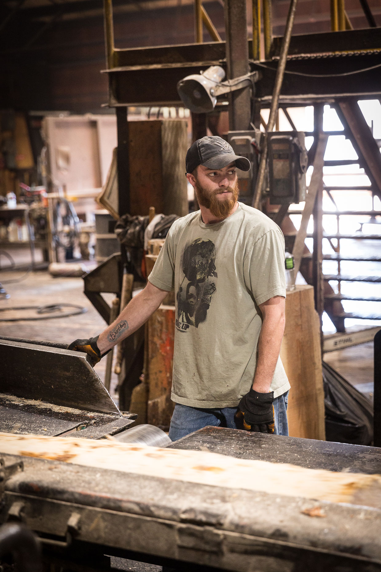 Male worker in lumber mill oversees sawing of wood, Malheur Lumber Company mill in John Day, Oregon by David Zaitz.