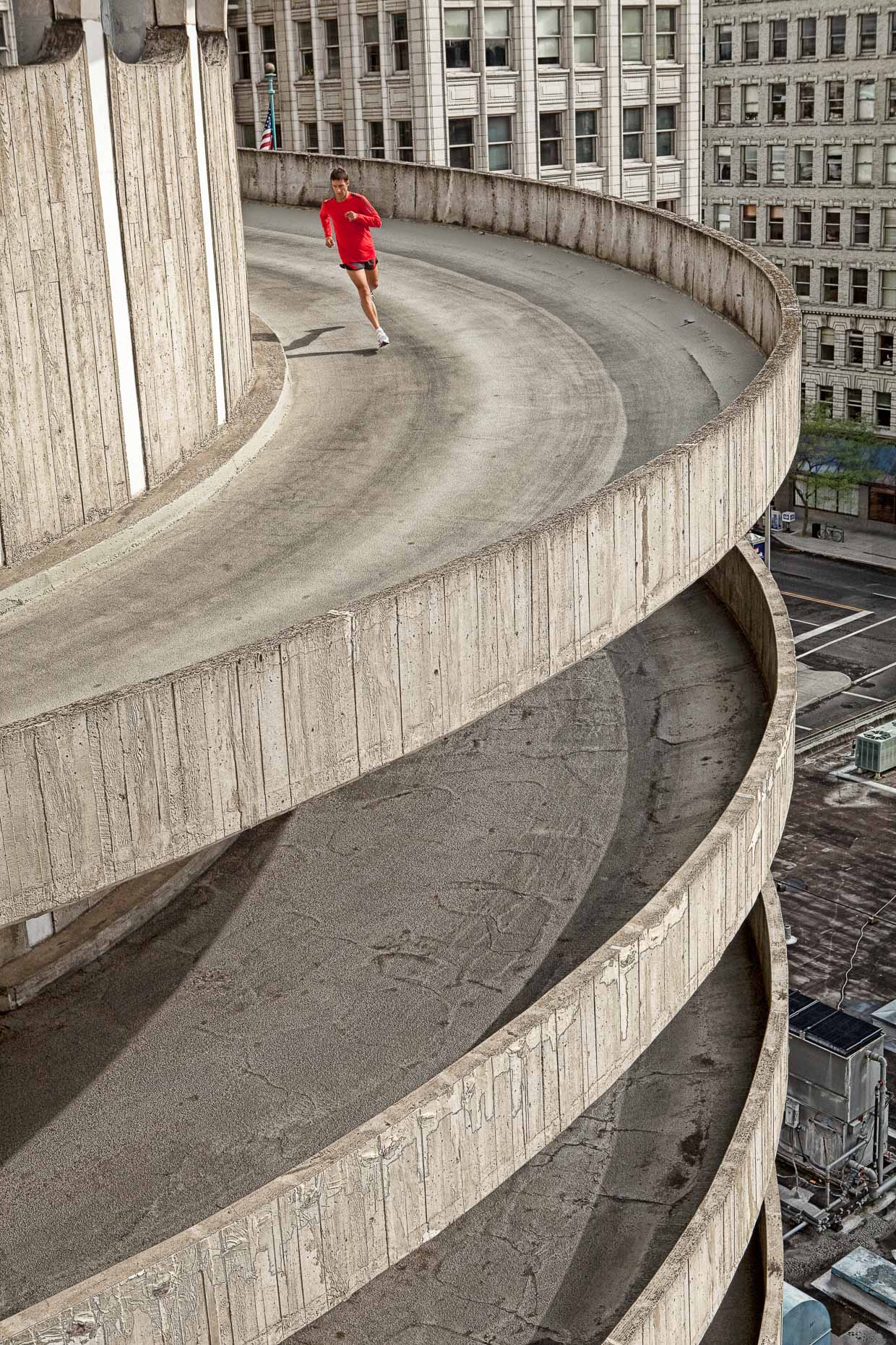 Man running on spiral concrete ramp of parking structure in Spokane, Washington by David Zaitz