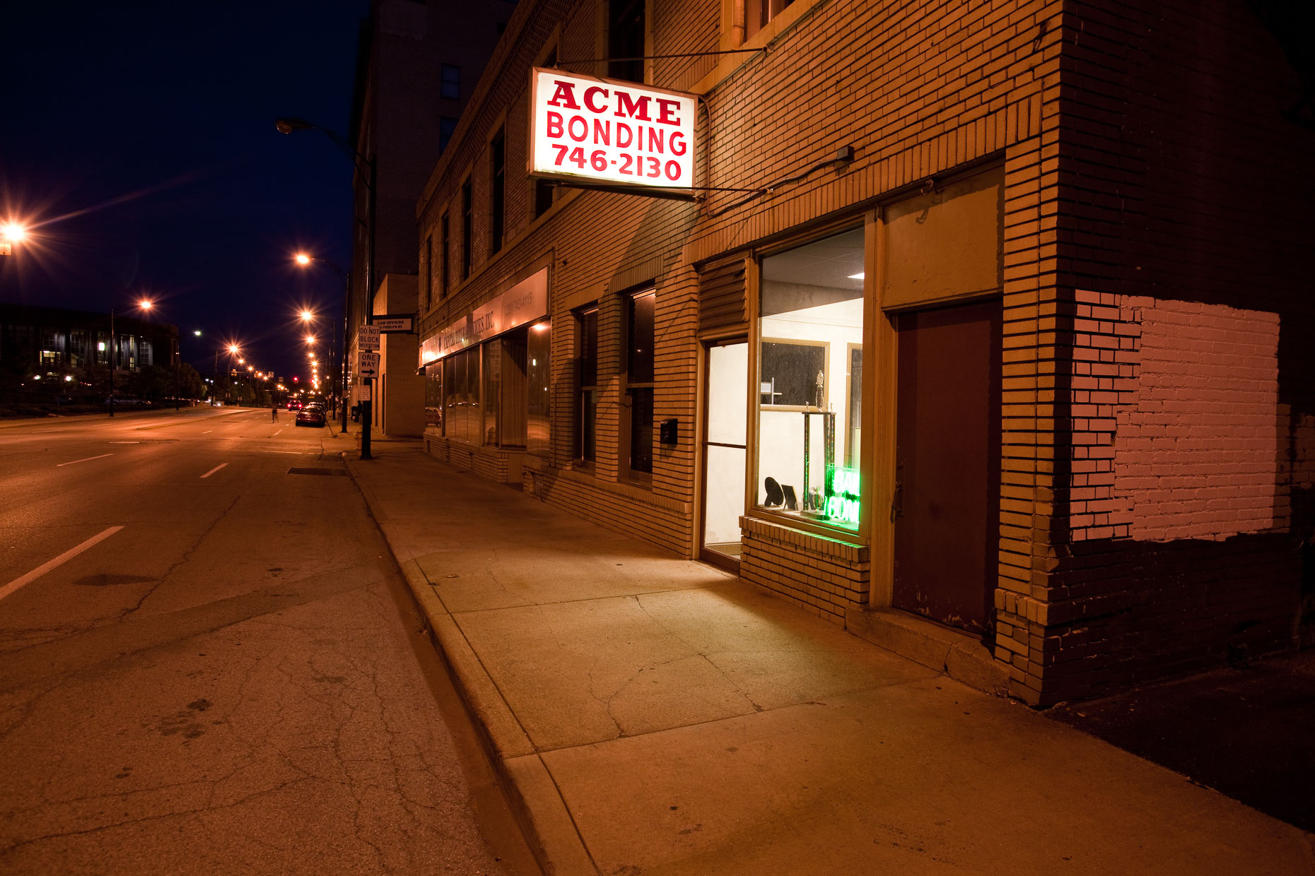Bail bonds office at night on city street by David Zaitz
