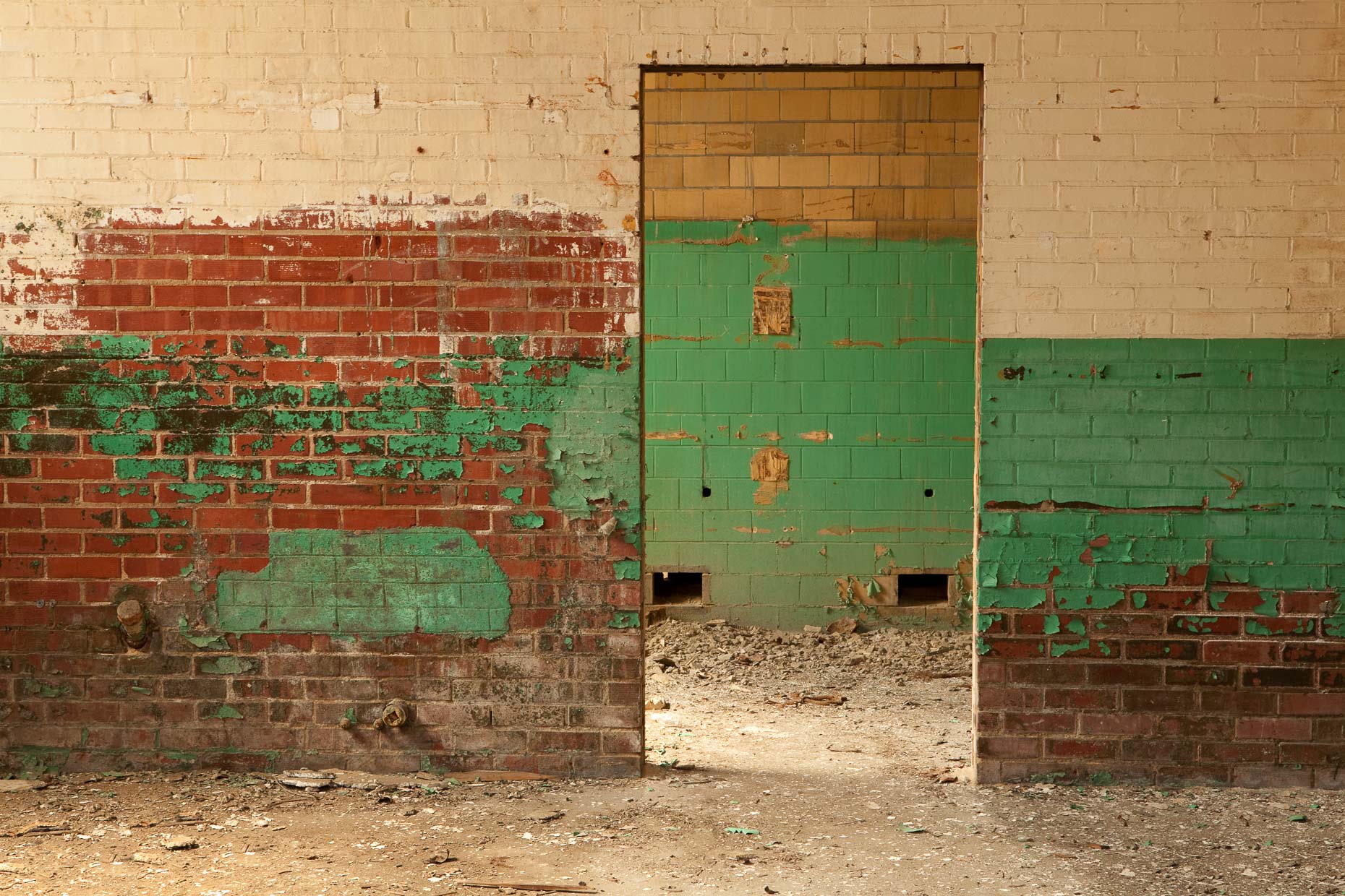Doorway with peeling paint in abandoned factory by David Zaitz