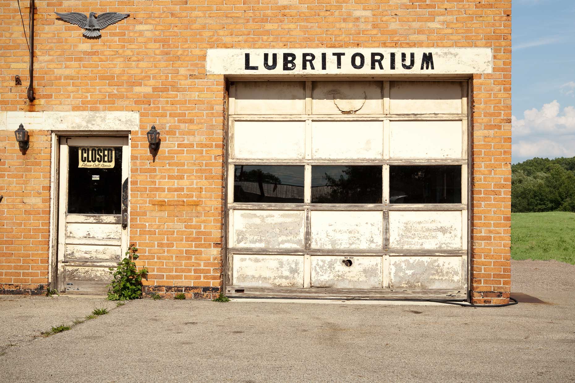 Brick commercial garage with LUBRITORIUM sign by David Zaitz