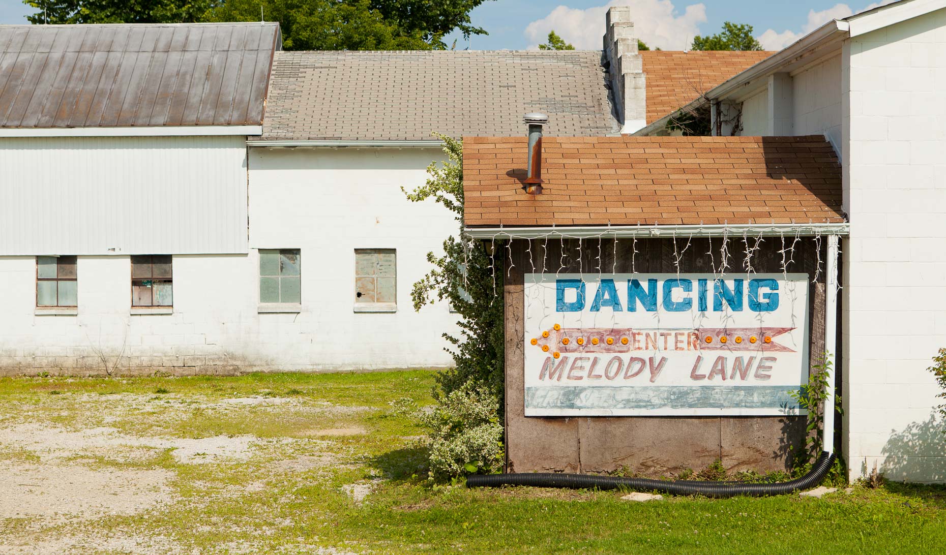Sign on building DANCING ENTER MELODY LANE by David Zaitz