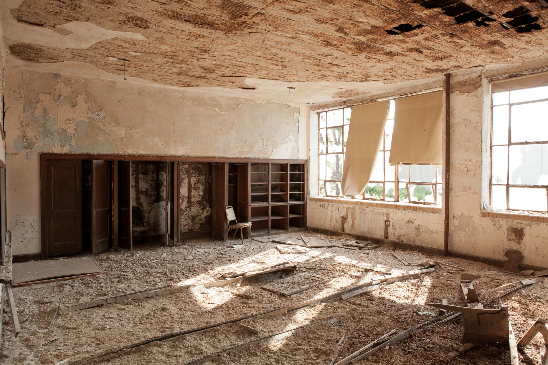 Interior classroom in abandoned school with peeling paint by David Zaitz