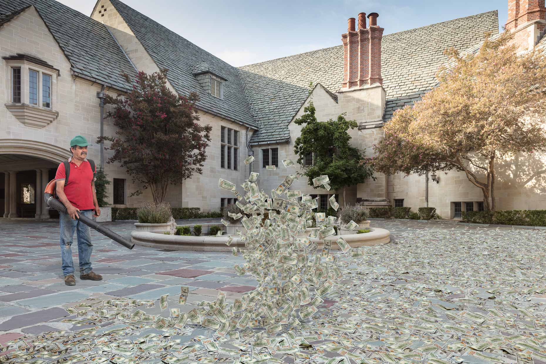 Gardener using leaf blower on hundred dollar bills on ground in courtyard of mansion.